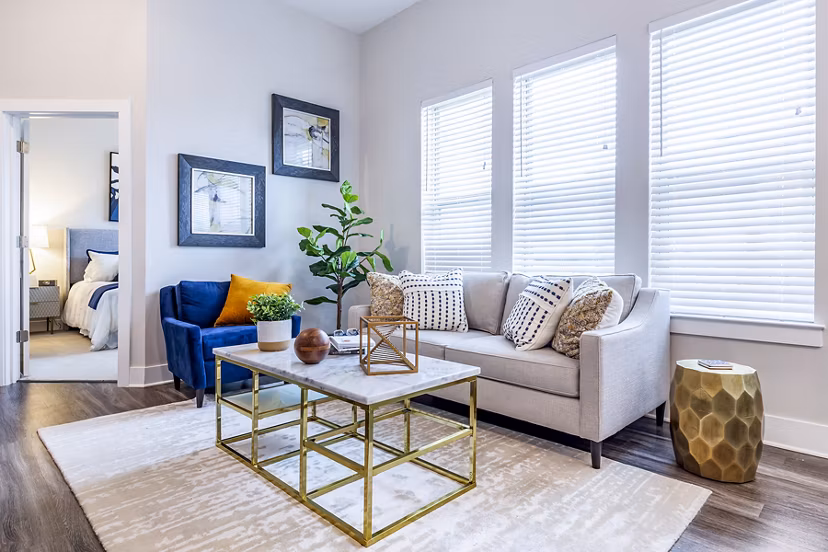 Modern living room with plush seating and ample natural light at Overture Providence Apartments, a Greystar luxury apartment community