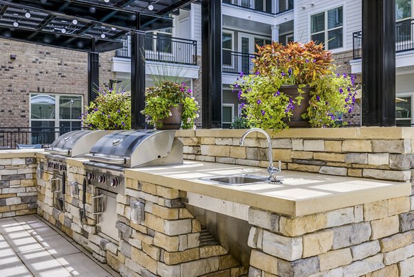 Outdoor grill area with modern seating at Overture Providence Apartments, perfect for social gatherings