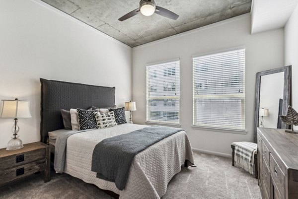 Elegant bedroom with modern decor in Gallery at Turtle Creek Apartments, showcasing luxury living