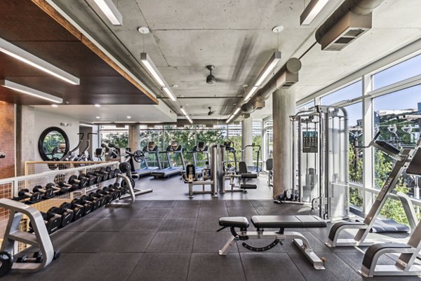 State-of-the-art fitness center at Gallery at Turtle Creek Apartments with modern equipment and bright interior design