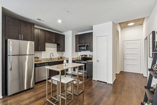 Modern kitchen with sleek countertops and stainless appliances in Gallery at Turtle Creek Apartments