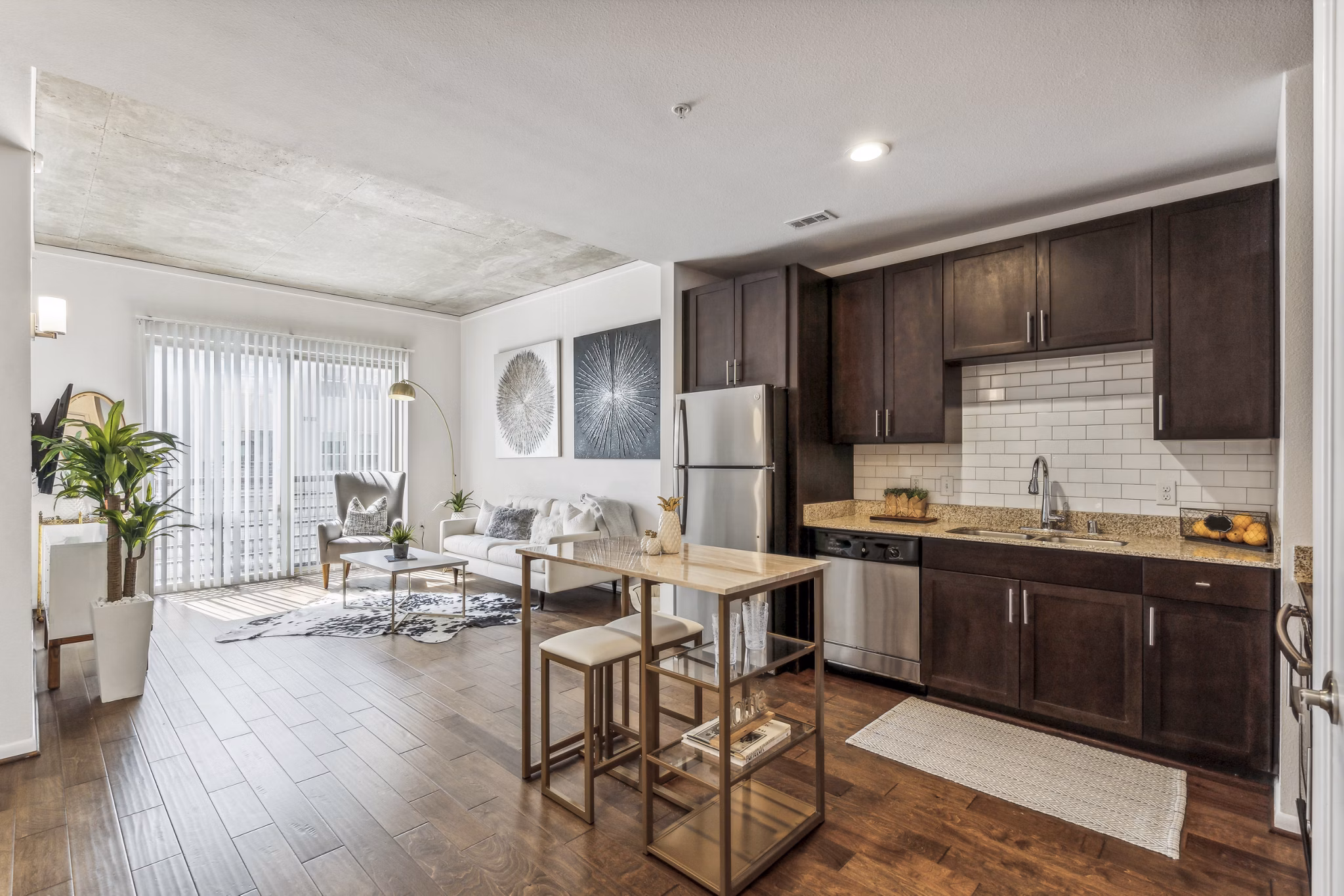 Modern kitchen with granite countertops and stainless steel appliances at Gallery at Turtle Creek Apartments