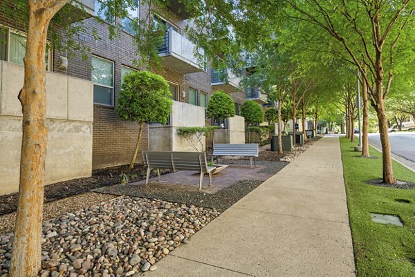 Courtyard view with lush greenery at Gallery at Turtle Creek Apartments, offering luxury living spaces in a serene environment