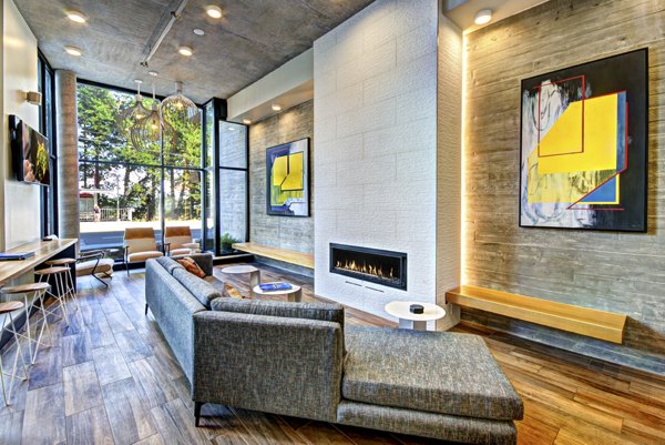 Contemporary clubhouse with stylish seating and game tables at Aura West Seattle Apartments