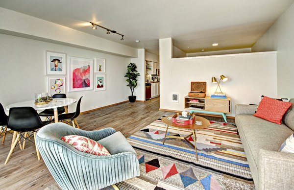 Modern living room with stylish decor and large windows at Aura West Seattle Apartments