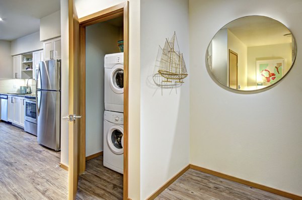 In-unit washer and dryer at Aura West Seattle Apartments featuring modern conveniences