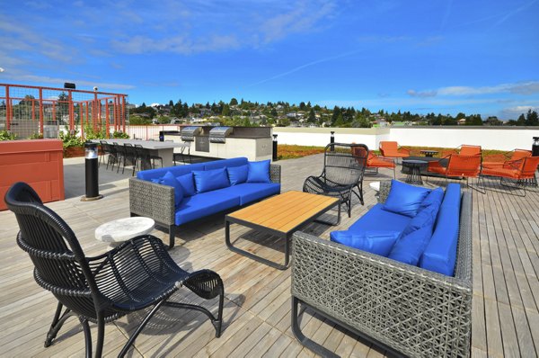Scenic rooftop patio at Aura West Seattle Apartments with city views, perfect for relaxation and gatherings