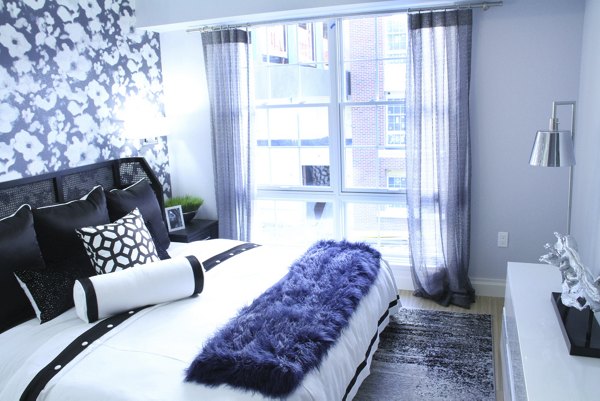 Cozy bedroom with modern decor at The Harper at Harmon Meadow Apartments