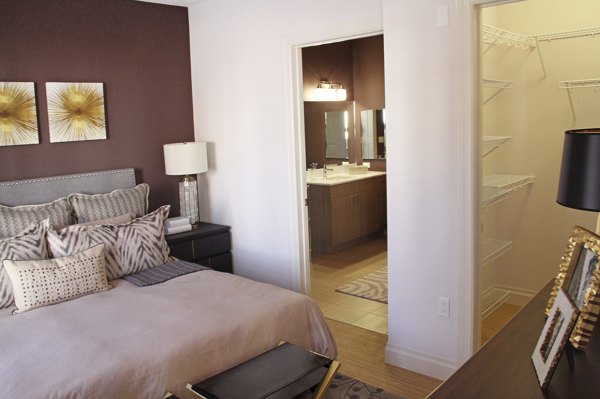 Elegant bedroom with expansive windows at The Harper at Harmon Meadow Apartments