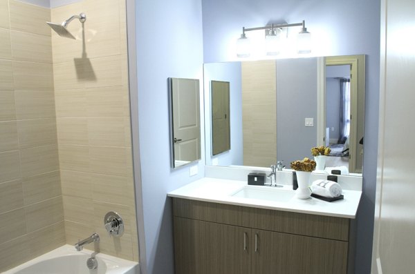 Modern bathroom with sleek fixtures at The Harper at Harmon Meadow Apartments