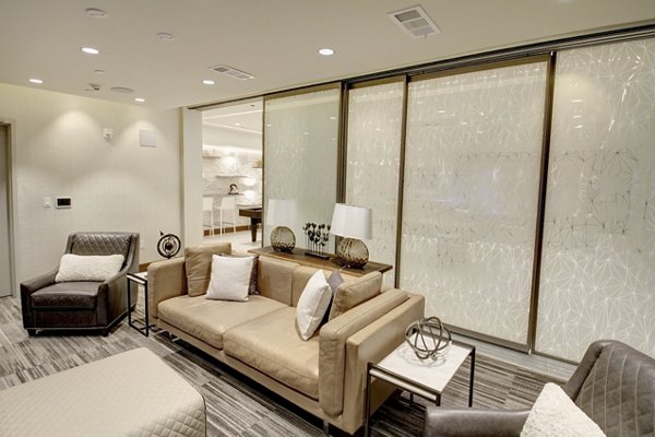 Theater room with comfortable seating at The Harper at Harmon Meadow Apartments