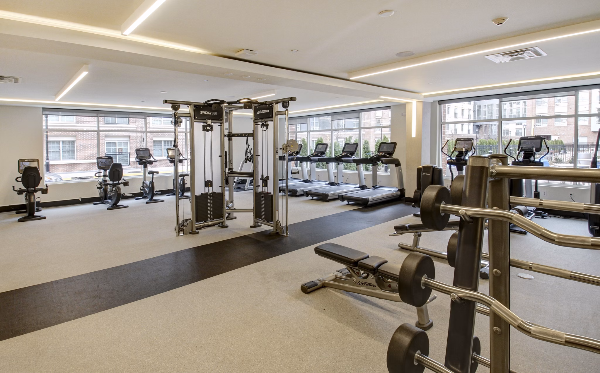 State-of-the-art fitness center with modern equipment at The Harper at Harmon Meadow Apartments