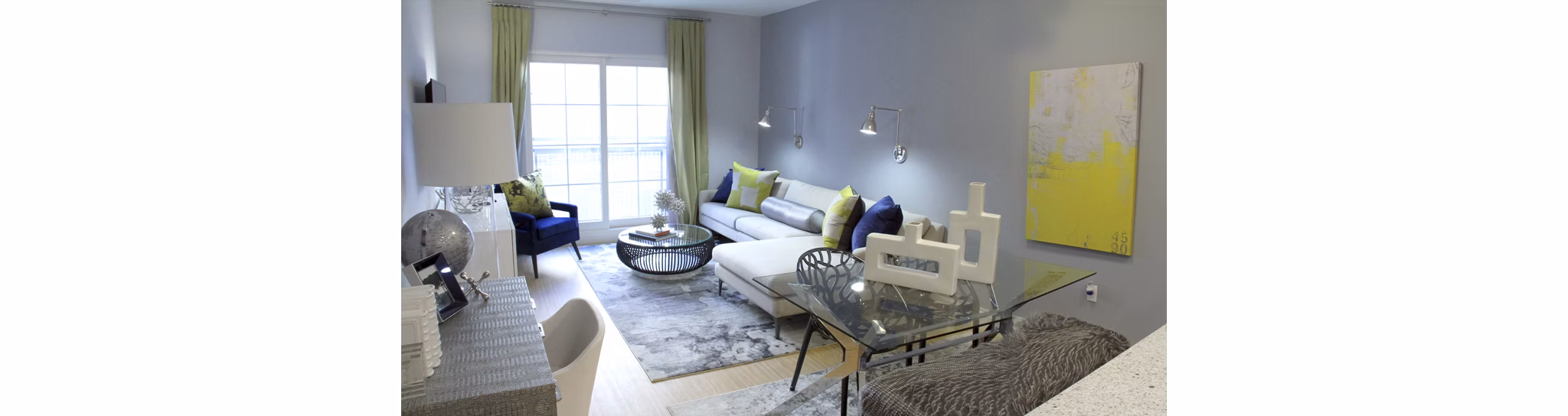 Living room with modern decor and large windows at The Harper at Harmon Meadow Apartments, luxury living by Greystar in New Jersey