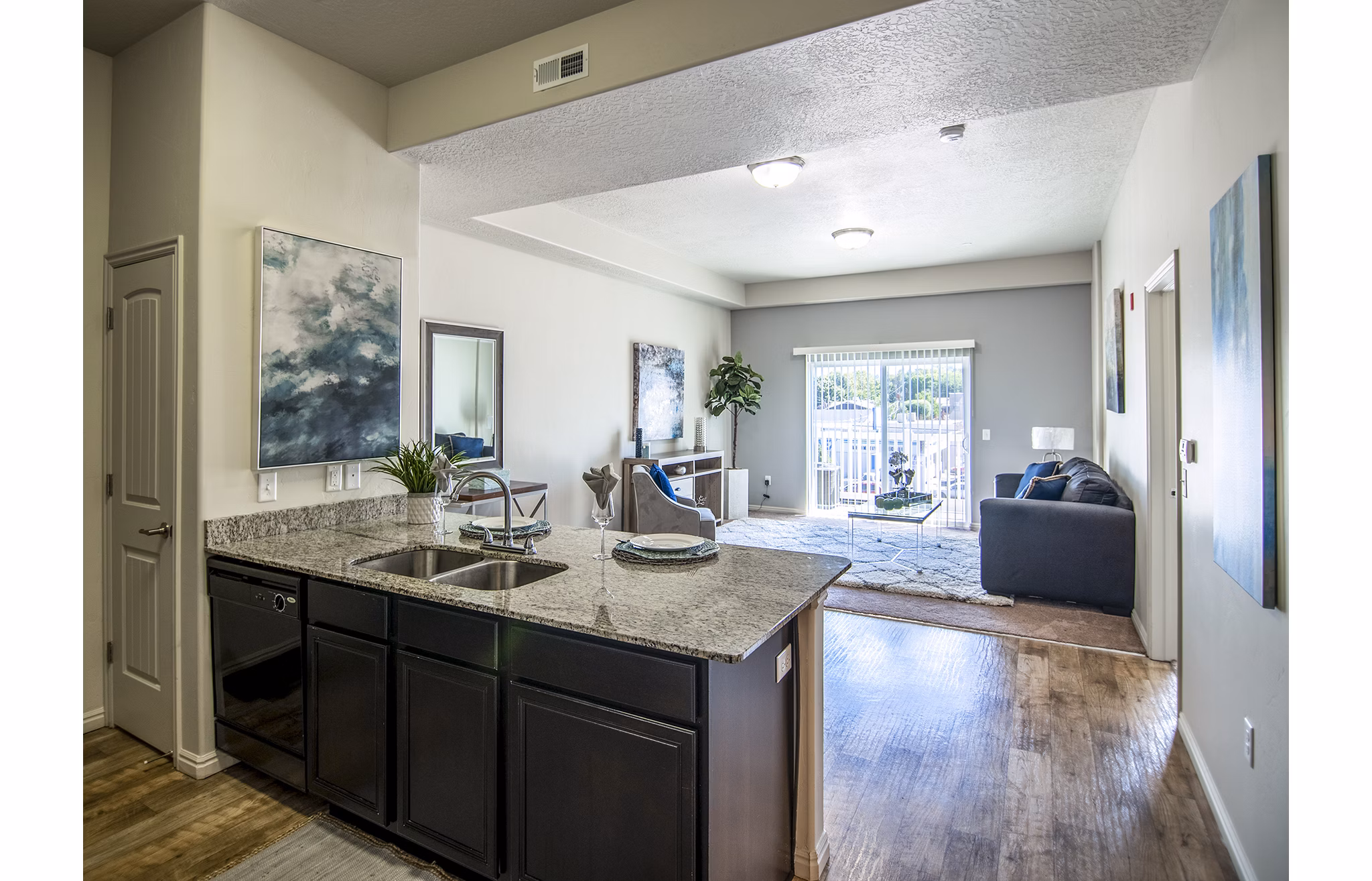 Modern kitchen with stainless steel appliances in Cottages on 7th, a 55+ community apartments