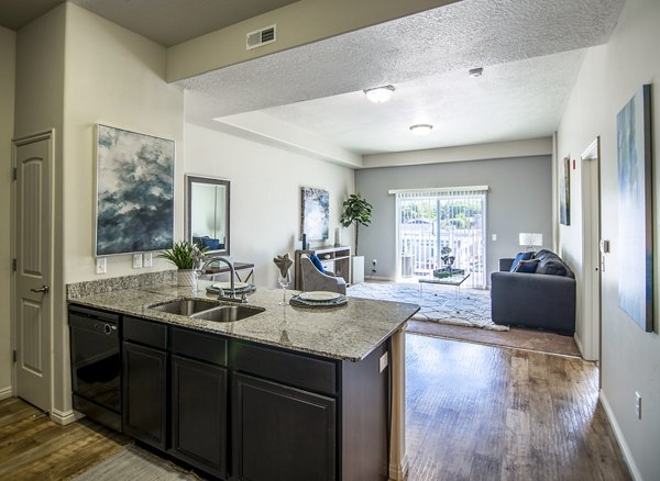 Modern kitchen with stainless steel appliances in Cottages on 7th, a 55+ community apartments