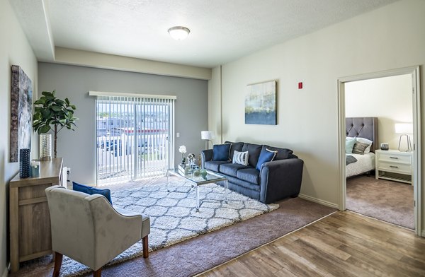 Cozy living room with plush seating and natural light in Cottages on 7th, a 55+ community apartments
