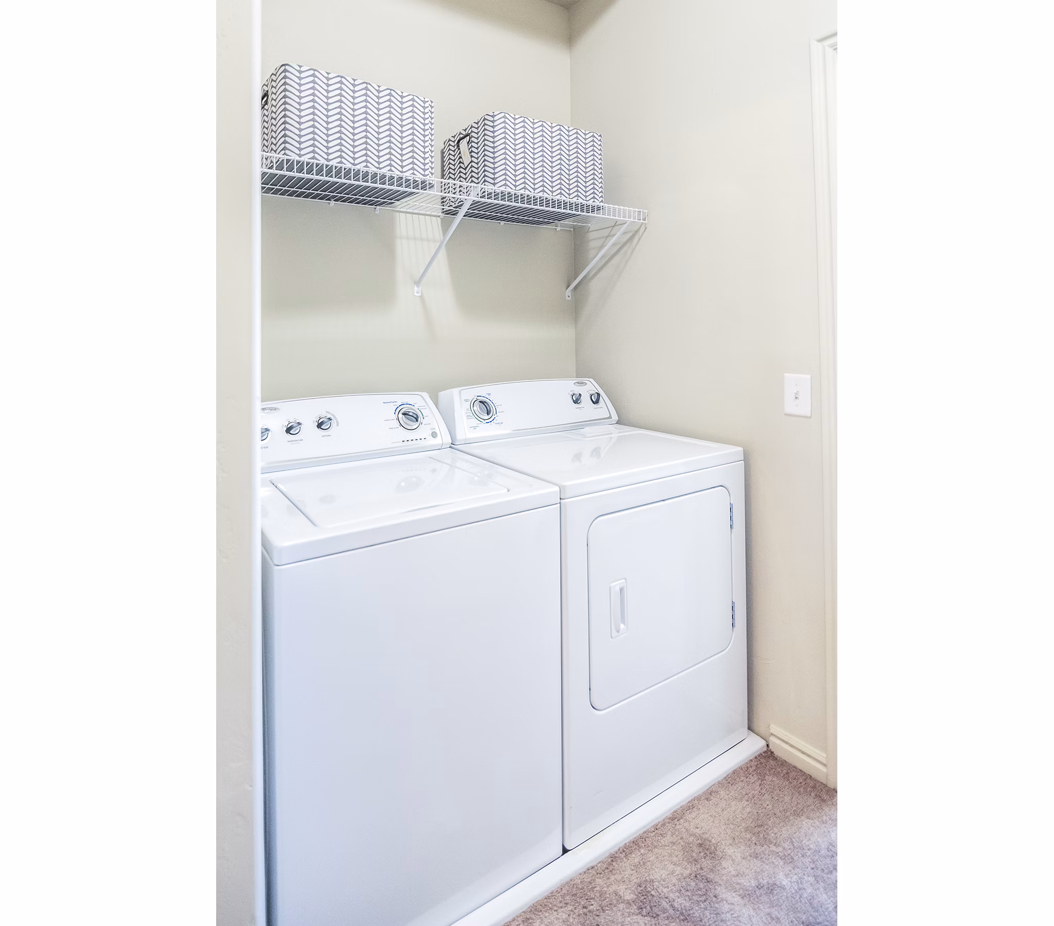 Efficient laundry room with modern appliances at Cottages on 7th, a 55+ community apartments