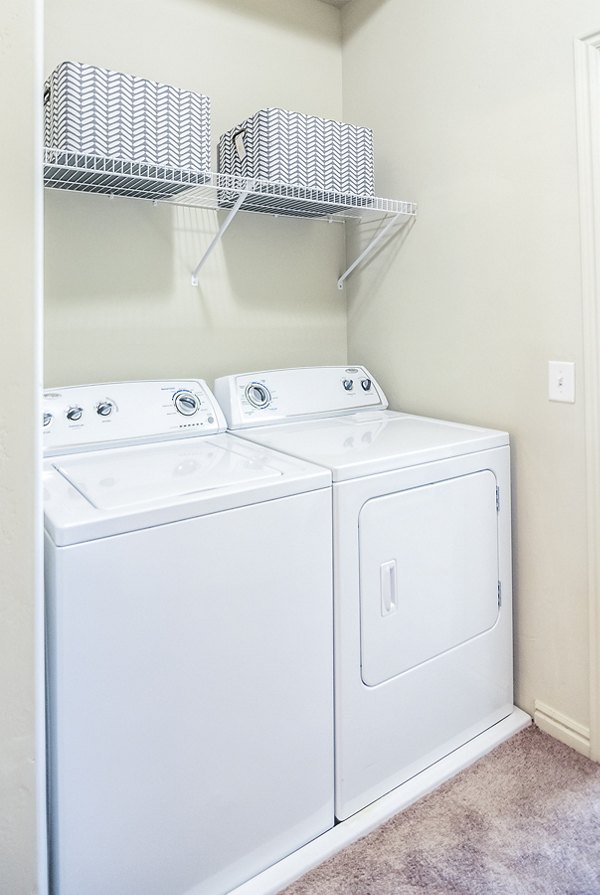 Efficient laundry room with modern appliances at Cottages on 7th, a 55+ community apartments