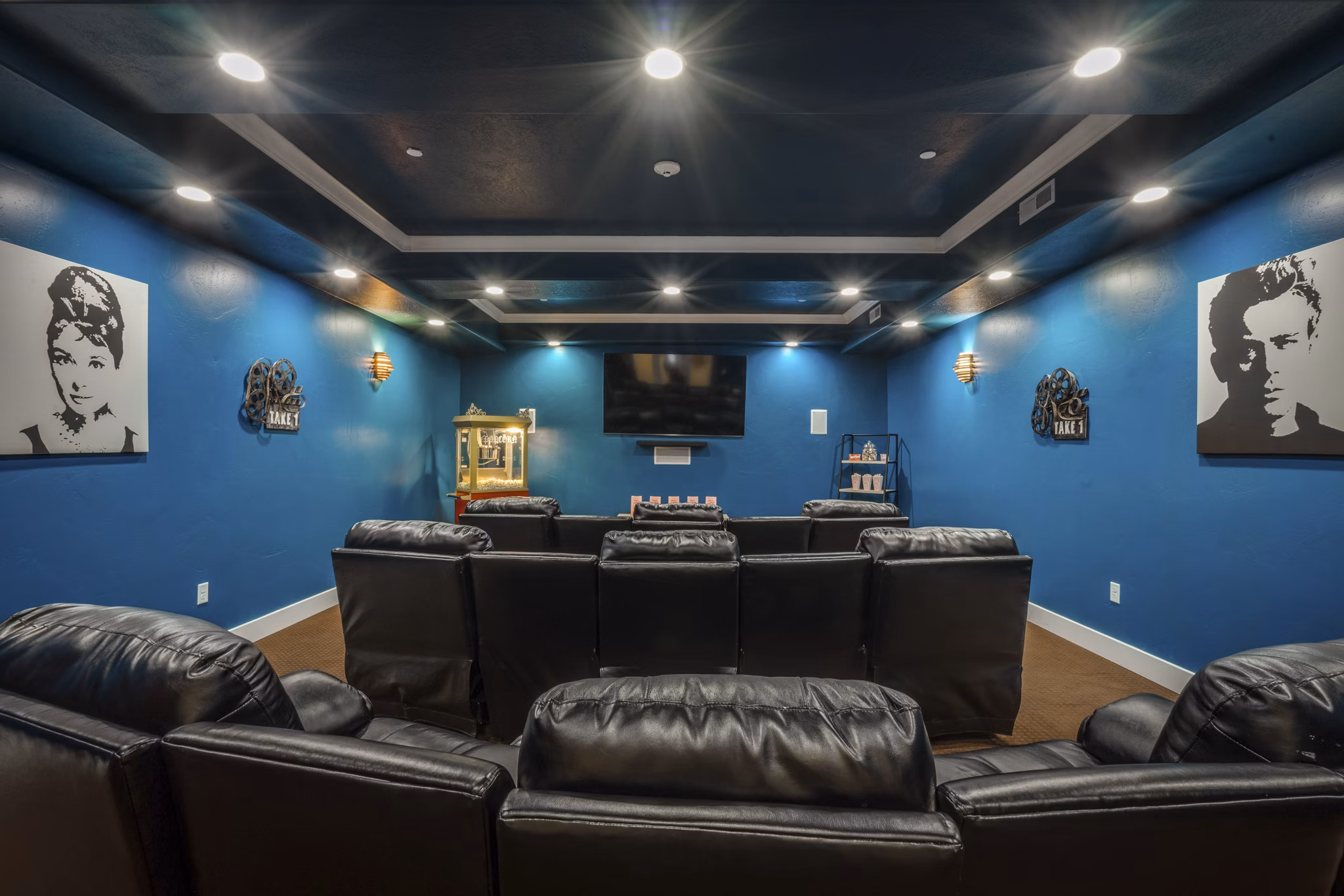 Movie room featuring plush seating at Cottages on 7th, a 55+ community ideal for relaxation and entertainment