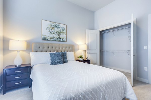 Bedroom featuring modern decor and large windows at Overture Yorktown Apartments
