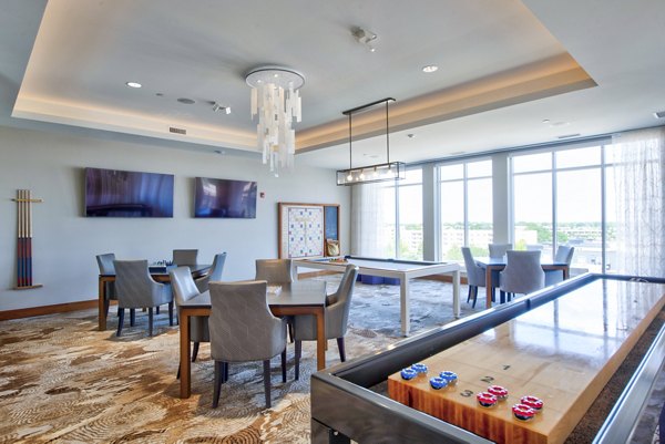 Clubhouse game room featuring billiards and lounge seating at Overture Yorktown Apartments