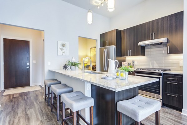 Modern kitchen with stainless steel appliances at Overture Yorktown Apartments