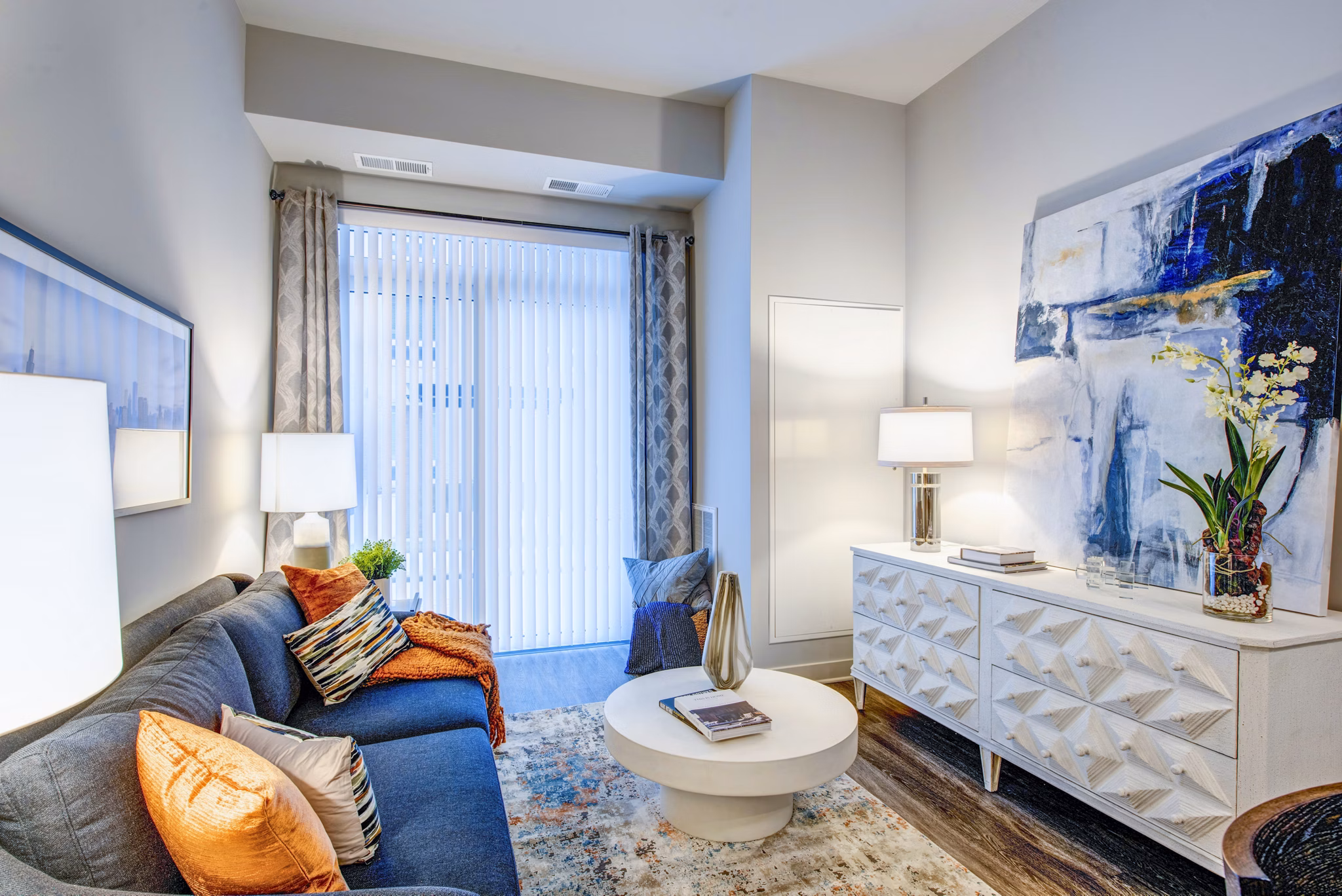 Living room featuring modern decor and large windows at Overture Yorktown Apartments, a luxury community offering stylish interiors