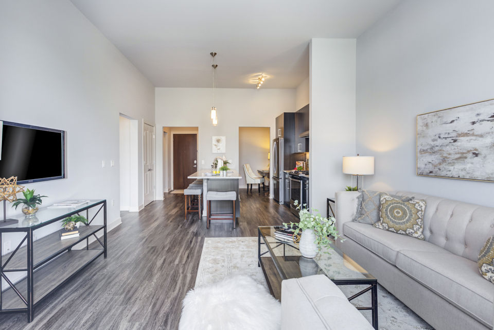 Spacious living room featuring modern furnishings and a large window at Overture Yorktown Apartments
