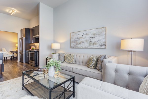 Modern living room with elegant decor and large windows at Overture Yorktown Apartments, offering luxury living in a vibrant community