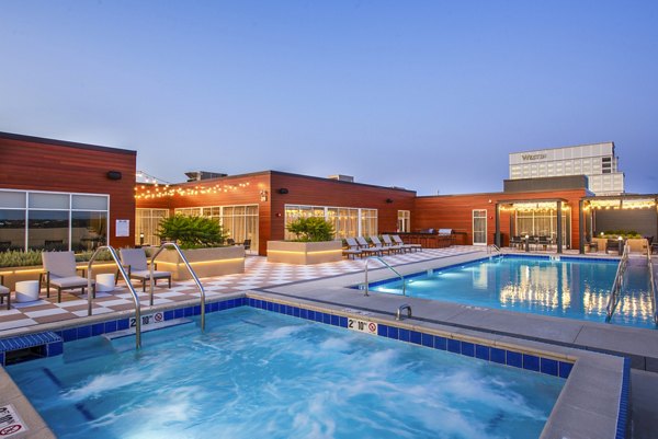 Rooftop pool with lounge chairs and scenic views at Overture Yorktown Apartments