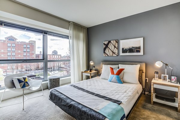 Modern bedroom with sleek furnishings at Zinc Apartments, featuring a serene design for comfortable living in a luxury community