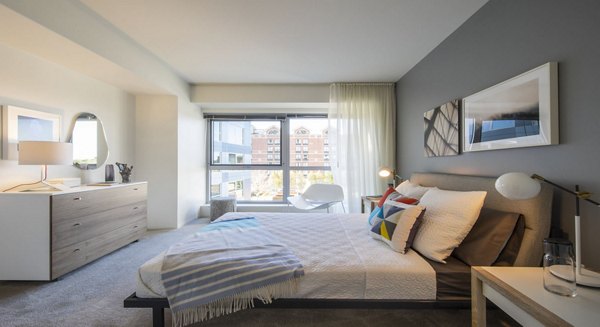 Cozy bedroom at Zinc Apartments featuring a plush bed and modern decor