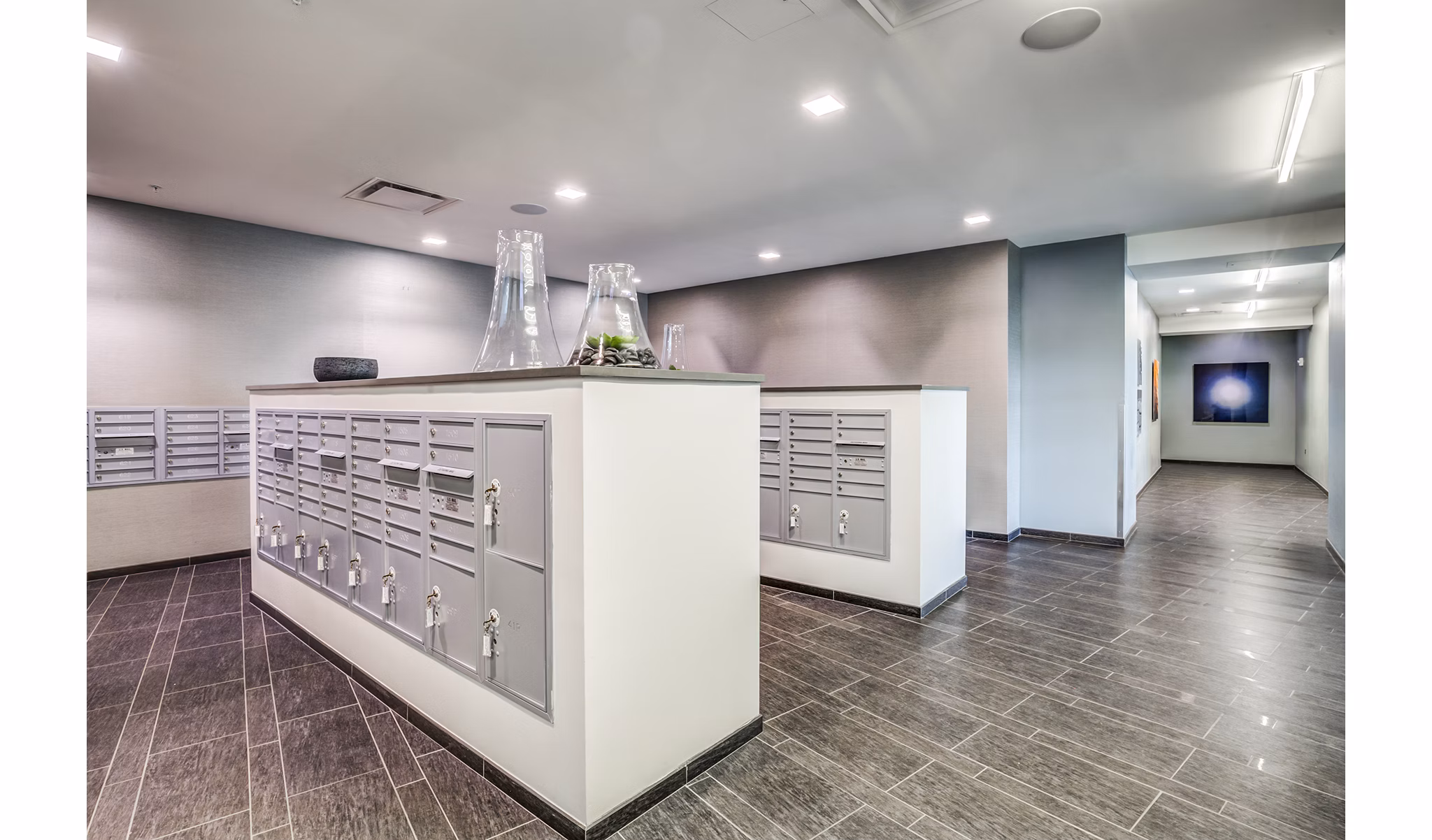 Mail room with secure package lockers at Zinc Apartments