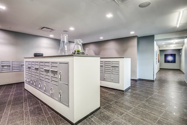 Mail room with secure package lockers at Zinc Apartments