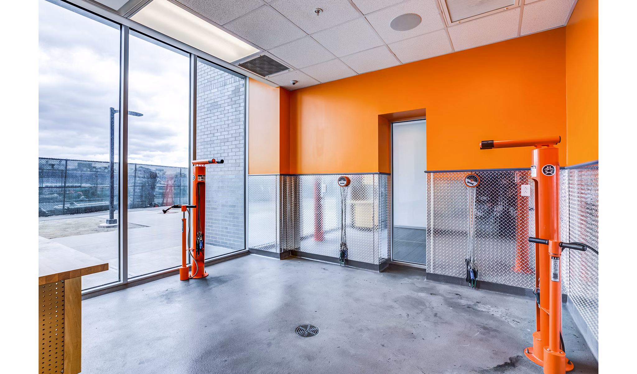 Outdoor bike maintenance station at Zinc Apartments featuring tools and storage for convenient repairs