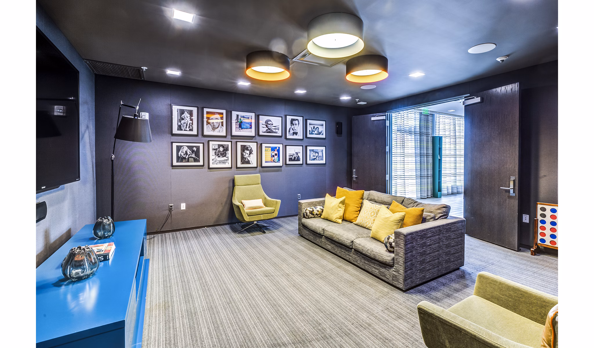 Clubhouse theater with plush seating and large screen at Zinc Apartments, luxury community offering premier entertainment options