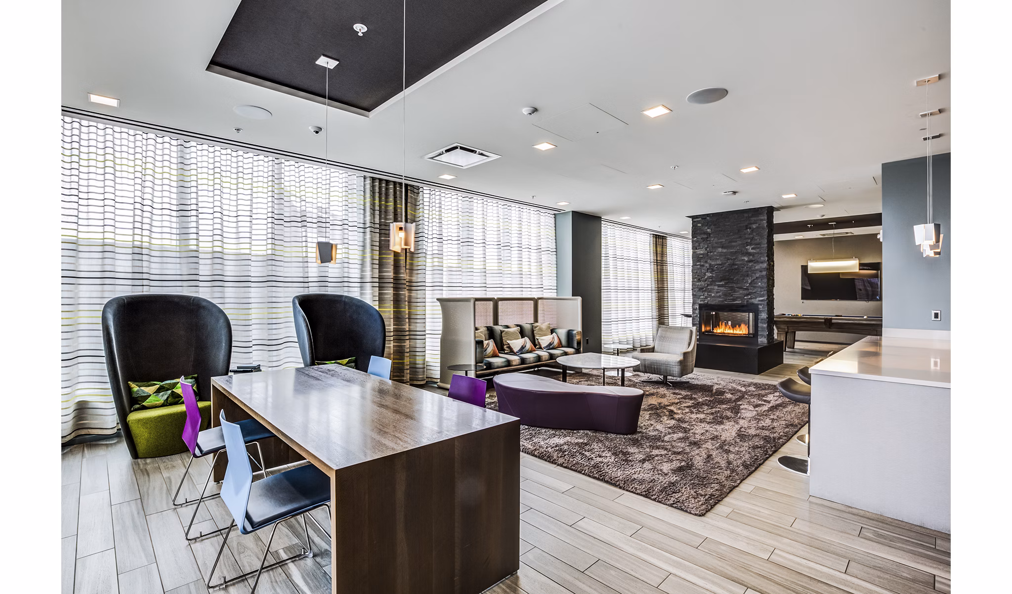 Clubhouse lobby with modern decor and seating at Zinc Apartments, a luxury community by Greystar