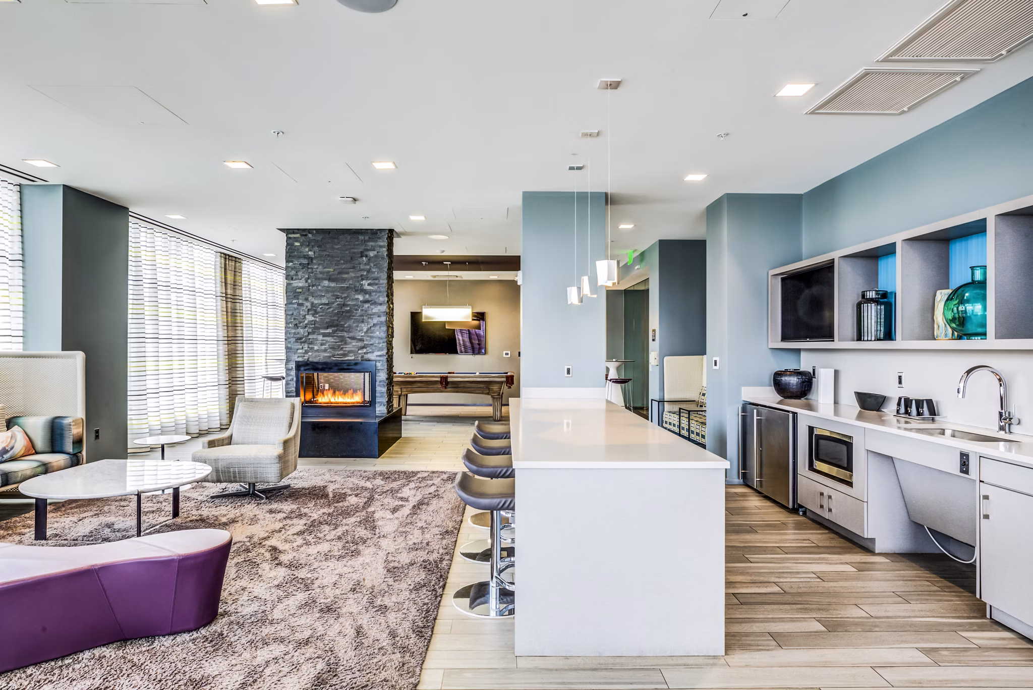 Modern clubhouse featuring lounge areas and entertainment space at Zinc Apartments in vibrant city setting