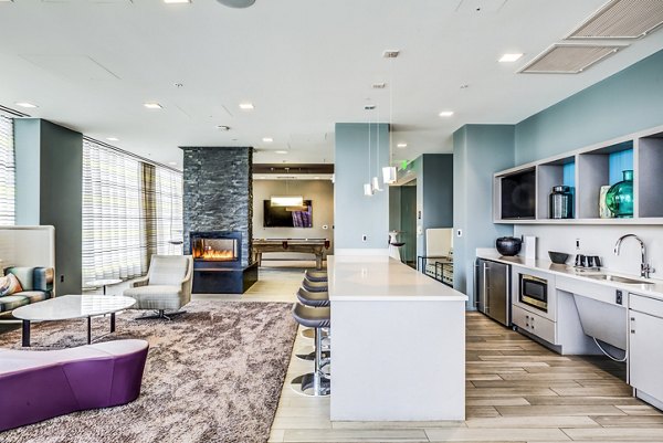 Modern clubhouse featuring lounge areas and entertainment space at Zinc Apartments in vibrant city setting