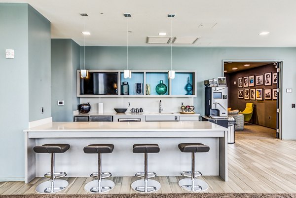 Chic clubhouse interior with modern decor at Zinc Apartments, ideal for social events and gatherings, enhancing luxury living experience