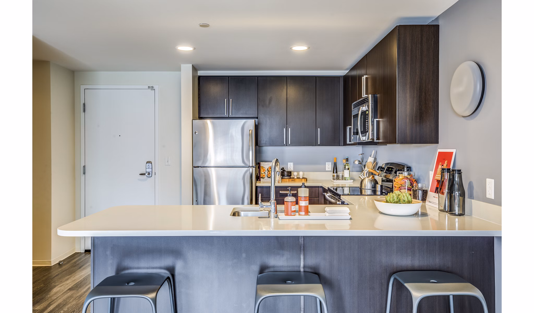 Modern kitchen with stainless steel appliances at Zinc Apartments