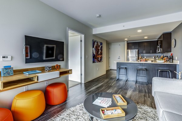 Contemporary living room with modern furnishings at Zinc Apartments, a Greystar luxury property