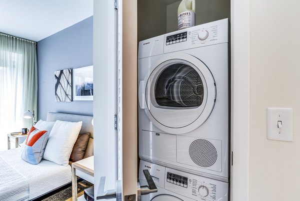 Laundry room with energy-efficient appliances at Zinc Apartments