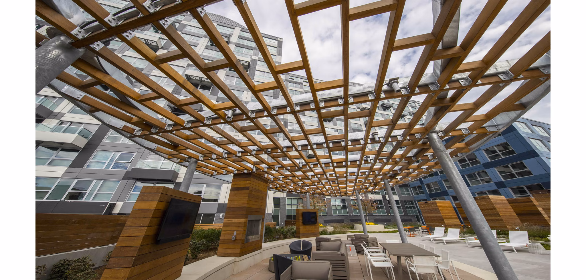 Outdoor recreational area with modern seating and greenery at Zinc Apartments