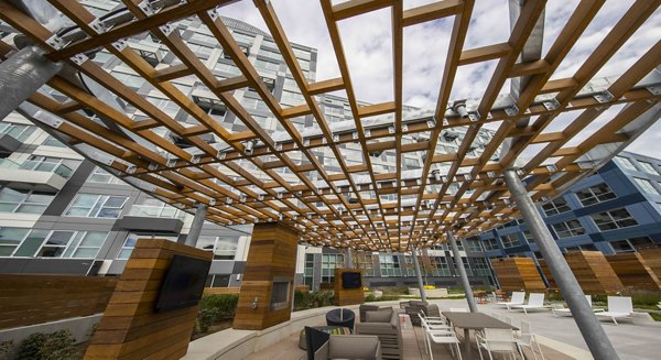 Outdoor recreational area with modern seating and greenery at Zinc Apartments