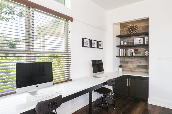 Business center equipped with modern workstations and computers at Pembroke Woods Apartments, ideal for remote work and meetings