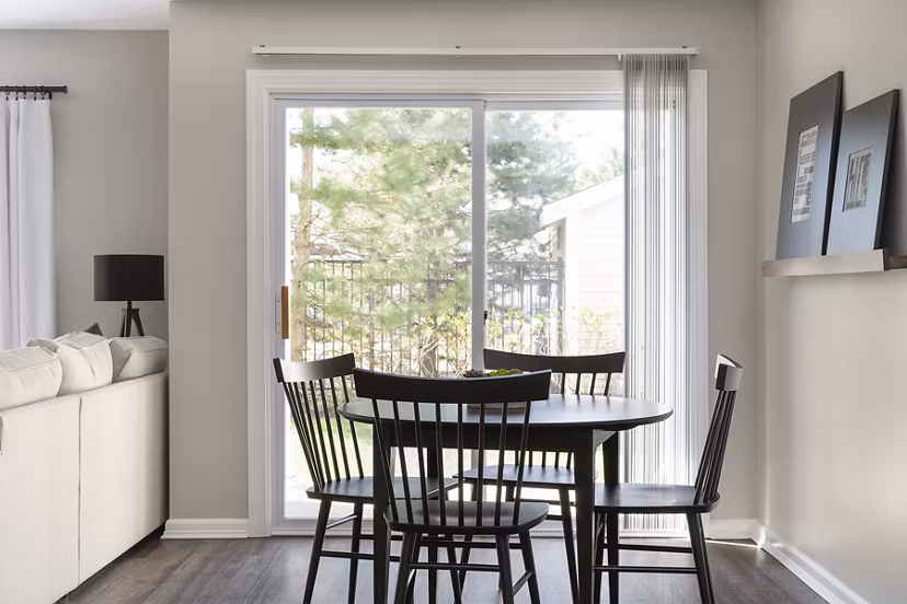 Dining room featuring elegant decor with large dining table and modern lighting at Pembroke Woods Apartments, luxury living in serene surroundings