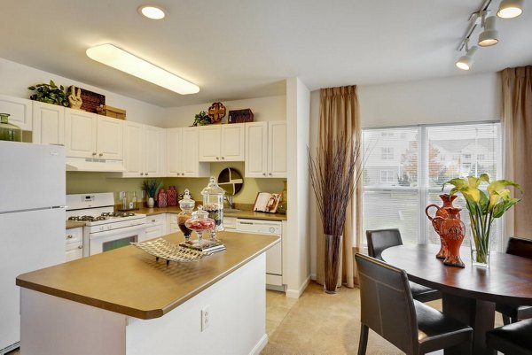 Modern kitchen with stainless steel appliances at Pembroke Woods Apartments