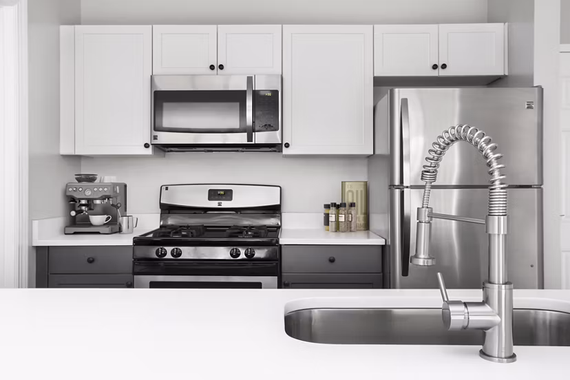 Modern kitchen featuring stainless steel appliances and granite countertops at Pembroke Woods Apartments