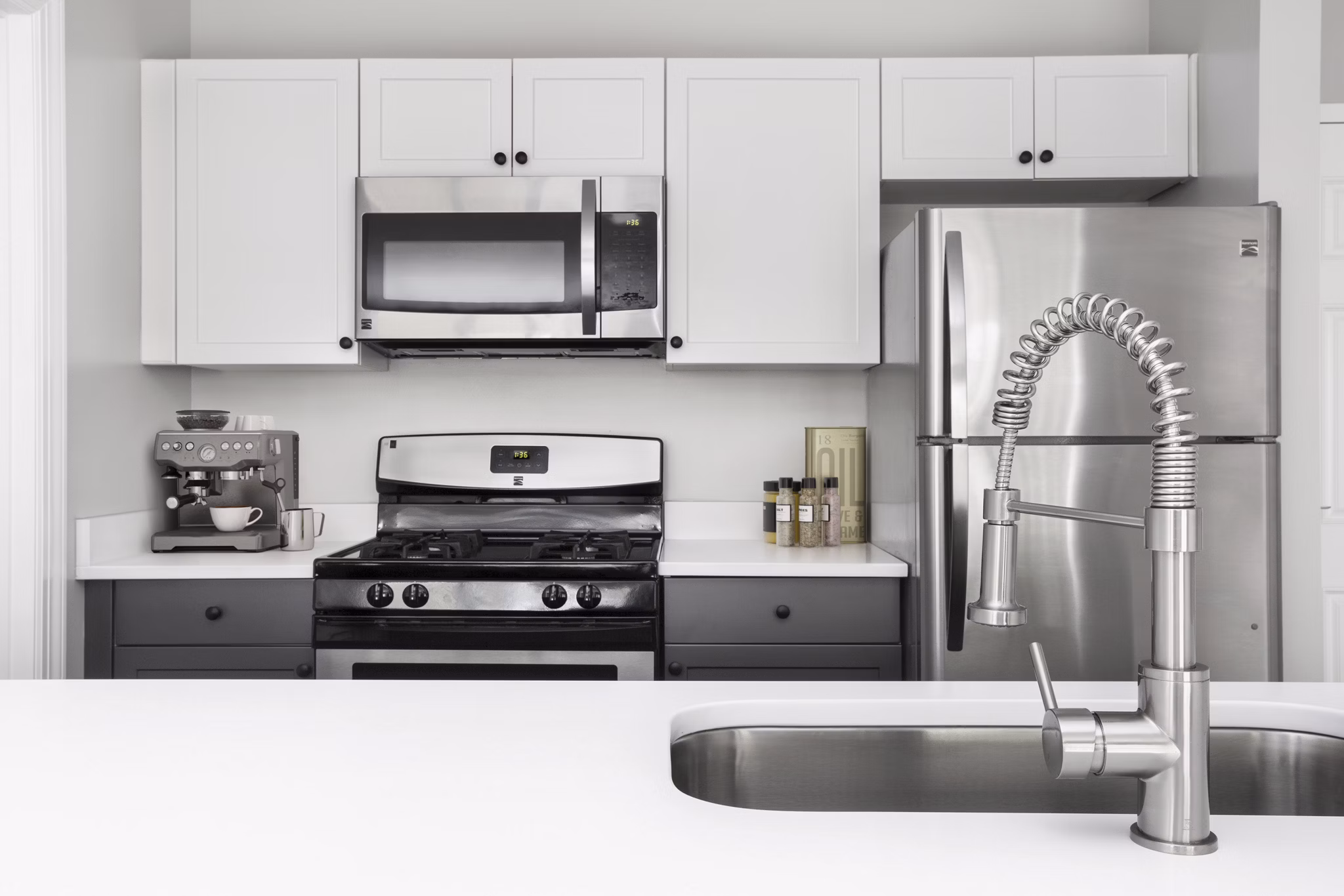 Modern kitchen featuring stainless steel appliances and granite countertops at Pembroke Woods Apartments